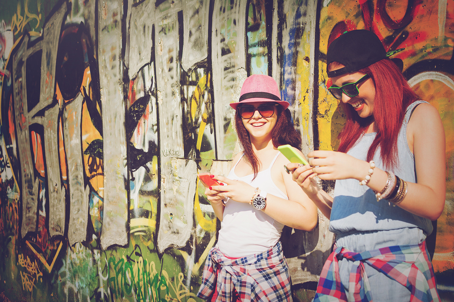 Millennial teenage girls with smart phones